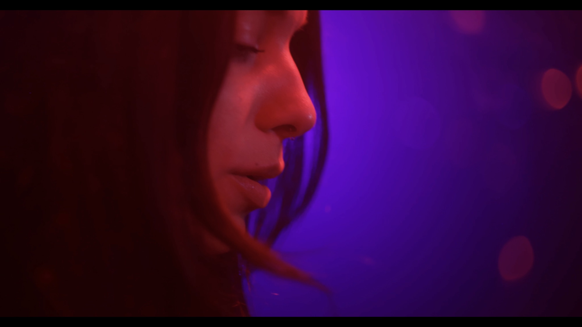 Stella silhouetted against violet stage light