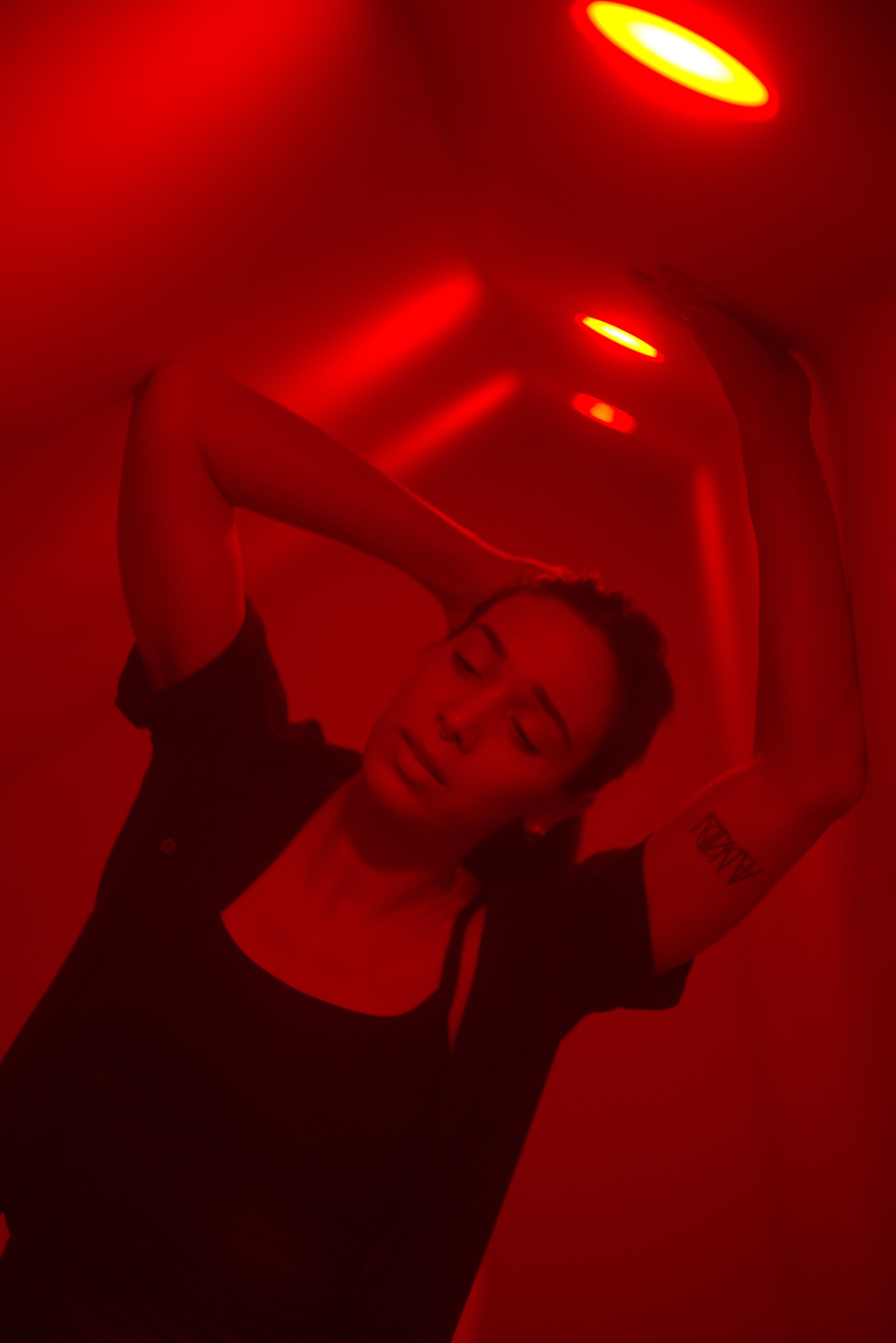 Stella moving beneath a corridor of cinematic red lights